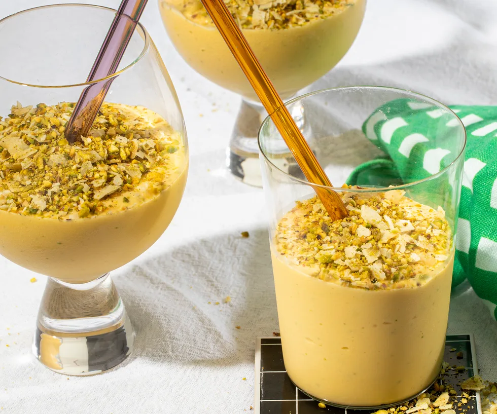 Three glasses of coconut, mango and lime lassi