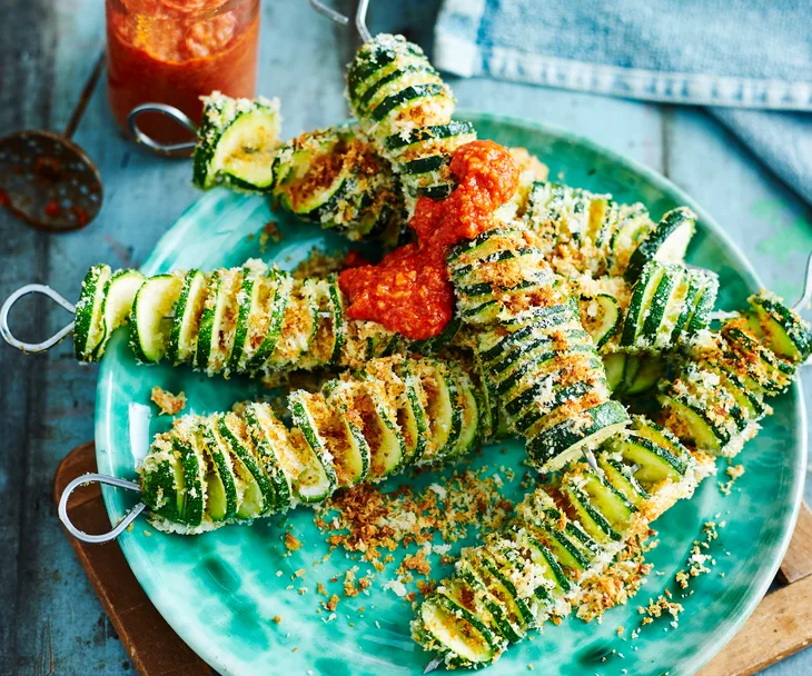 Crumbed zucchini skewers with romesco sauce