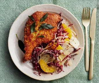 Plate of double-crumbed pork cotoletta with salad