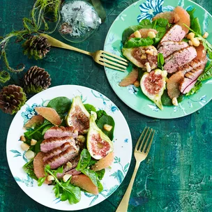 Aerial shot of two plates of duck and fig salad.