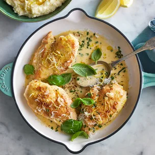 An aerial view of a cooking pan with lemon parmesan pan chicken, one of our popular chicken breast recipes