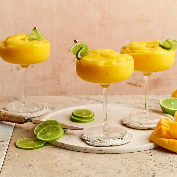 Three mango daiquiris in cocktail glasses