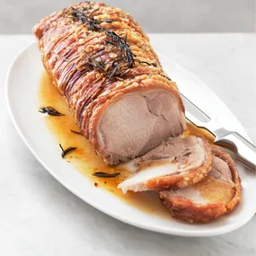 Pork loin roast with crackling on a platter