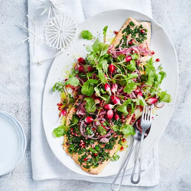 Barbecued ocean trout with pomegranate topping on plate