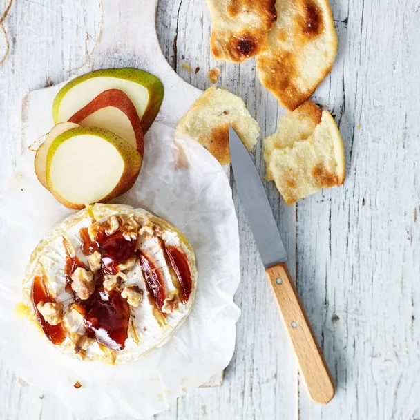 Baked brie with quince and walnuts, and sliced pear and crackers on the side