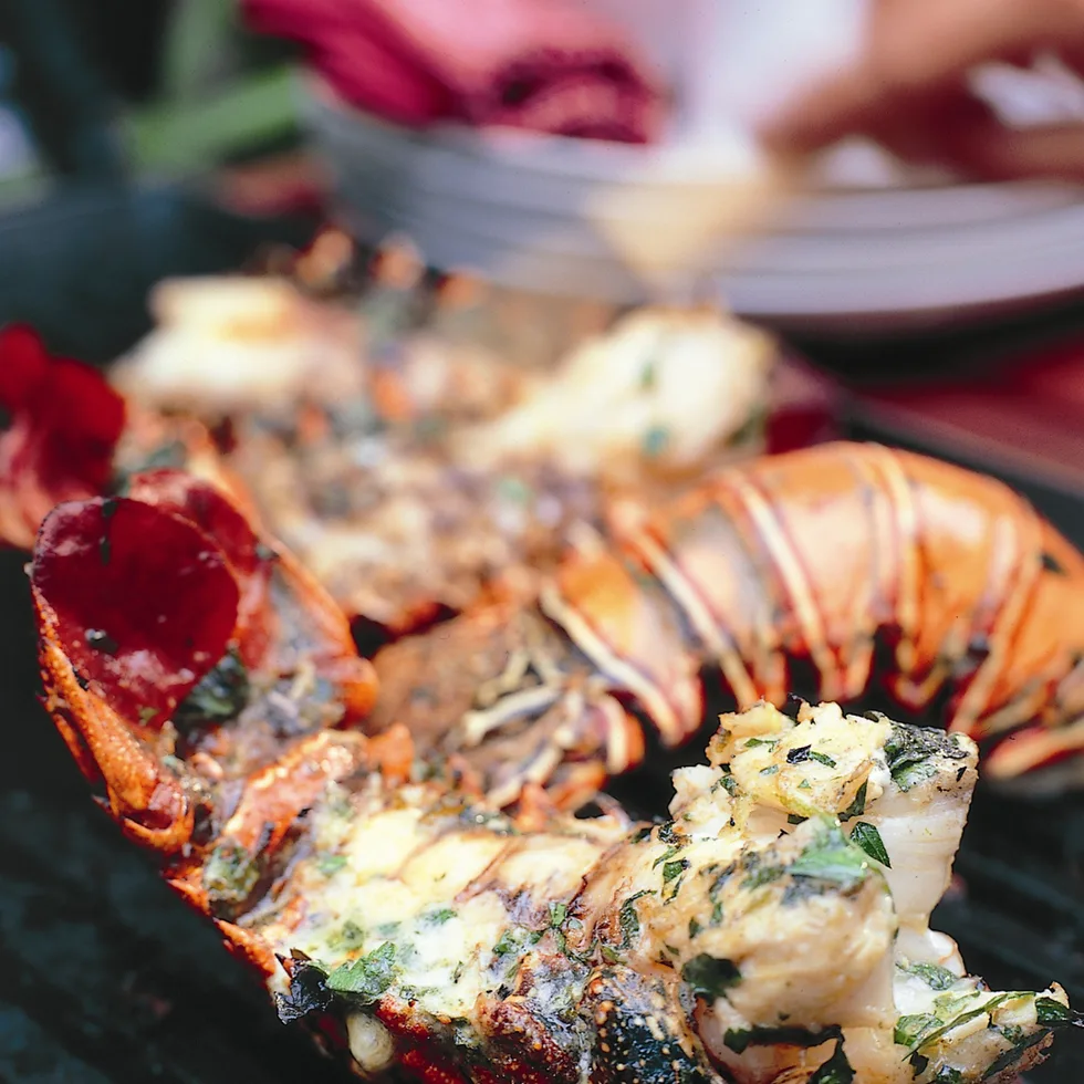 Lobster tails with lime & herbs on a chopping board