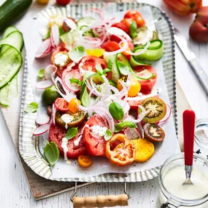 Summer tomato salad with creamed fetta on a platter