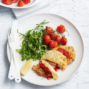 Air fryer chicken parmi with rocket and roasted truss tomatoes