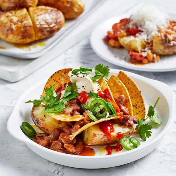 Air fryer jacket baked potato with butter, nachos topper and baked barbecue beans topper