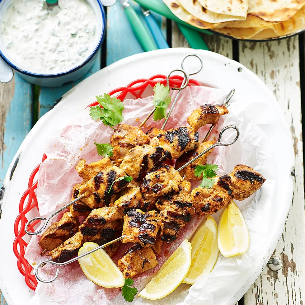 Julie Goodwin's tandoori chicken skewers served with yogurt sauce, lemon wedges, coriander leaves and roti