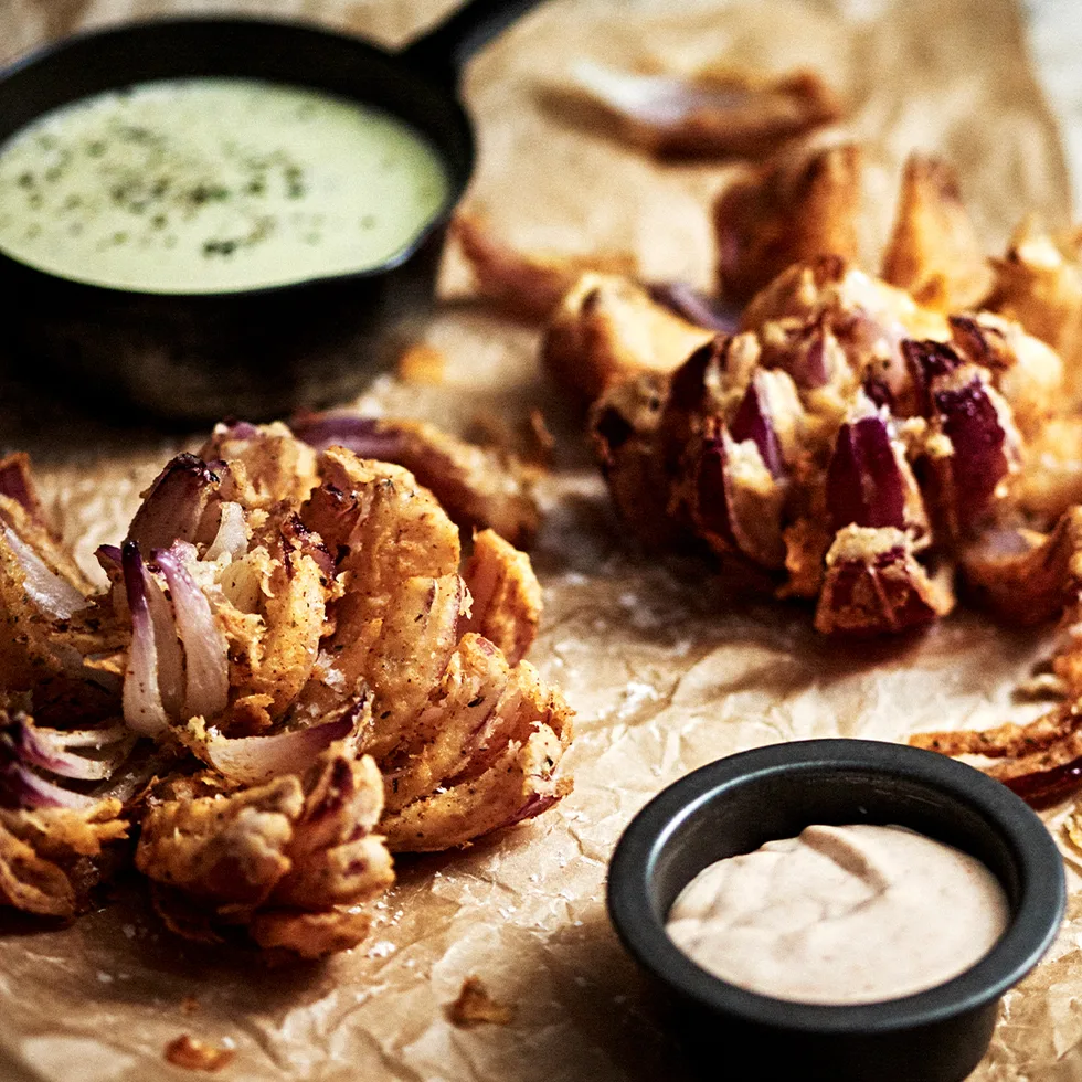 Blooming onions with warm cider cheese sauce and creamy tomato and horseradish sauce