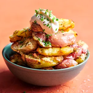 A bowl filled with crispy roast potatoes.
