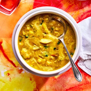 bowl of corn chowder with coconut and lentils