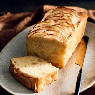 Apple loaf cake with a slice cut, ready to serve