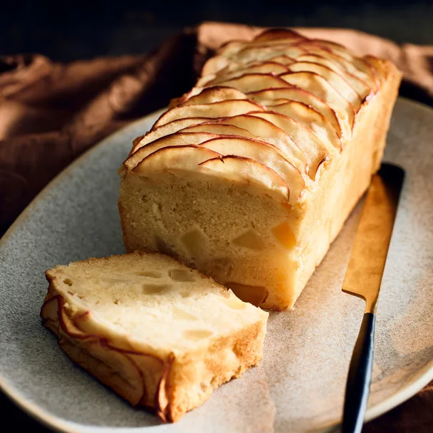 Apple loaf cake with a slice cut, ready to serve