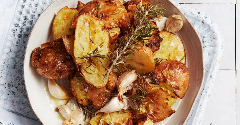 Air fryer potatoes with salt & vinegar on a white serving dish