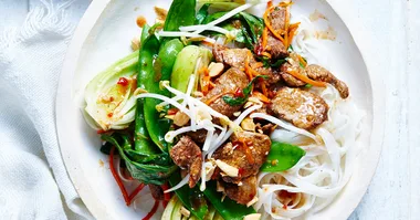 Five spice pork stir fry with on a white plate with noodles