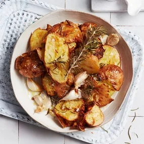 Air fryer potatoes with salt & vinegar on a white serving dish