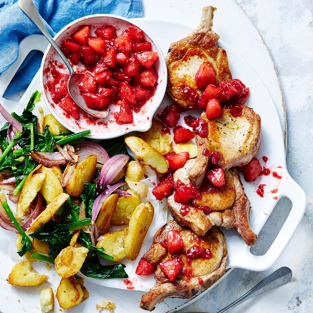 Pork cutlets with apple berry sauce with potatoes, spinach and onion