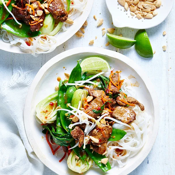 Five spice pork stir fry with on a white plate with noodles