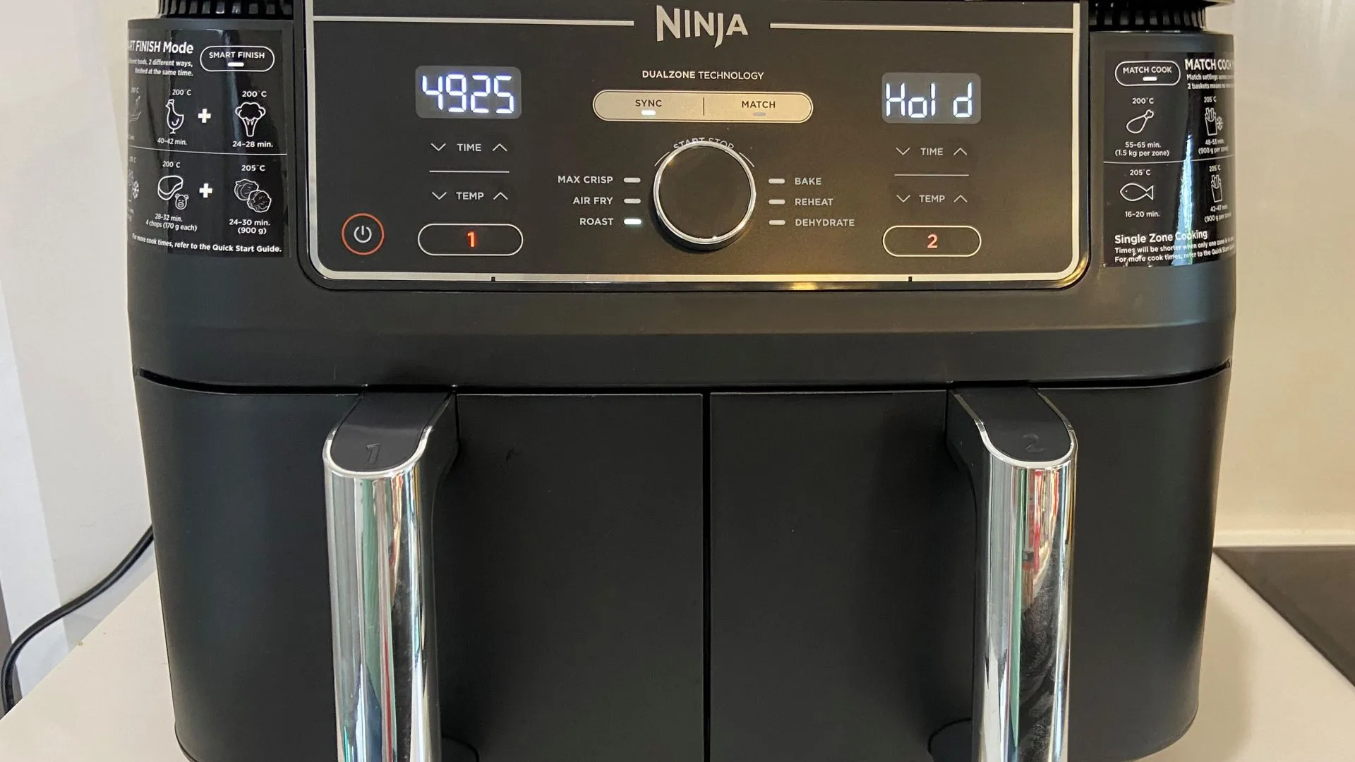 The Ninja Dual Zone Air Fryer with both drawers cooking different things using the Sync function so they are ready at the same time.
