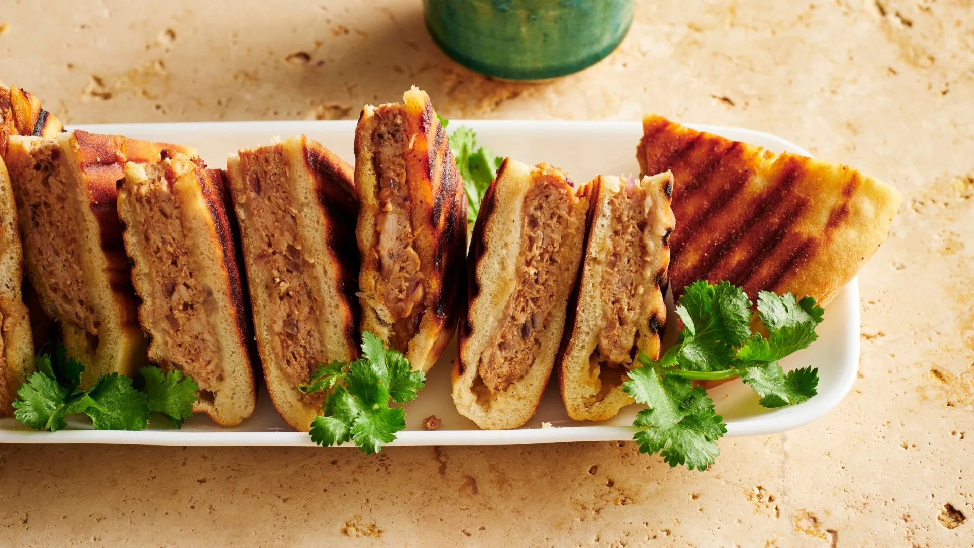 Chicken shawarma pitas cut into triangles on a platter