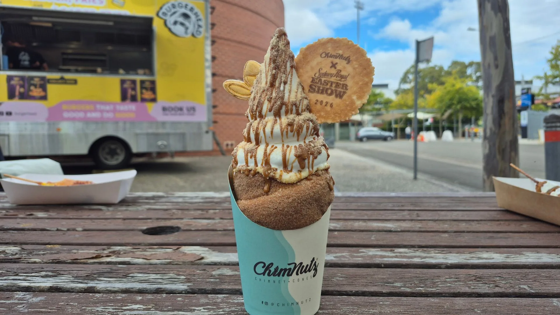 funnel cake with vanilla ice-cream drizzled with caramel sauce on a table at the Royal Easter Show 2026 showground