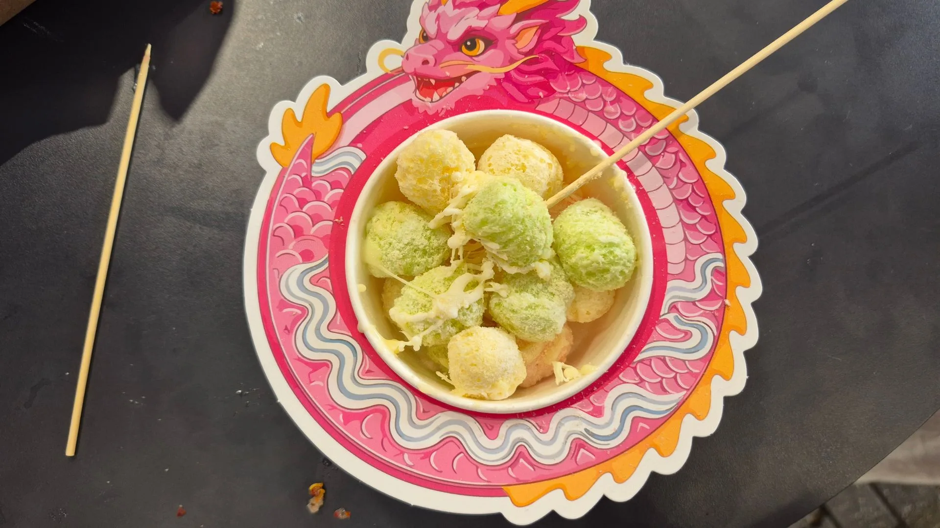 colourful corn puffs in a bowl with a dragon illustration around the edge