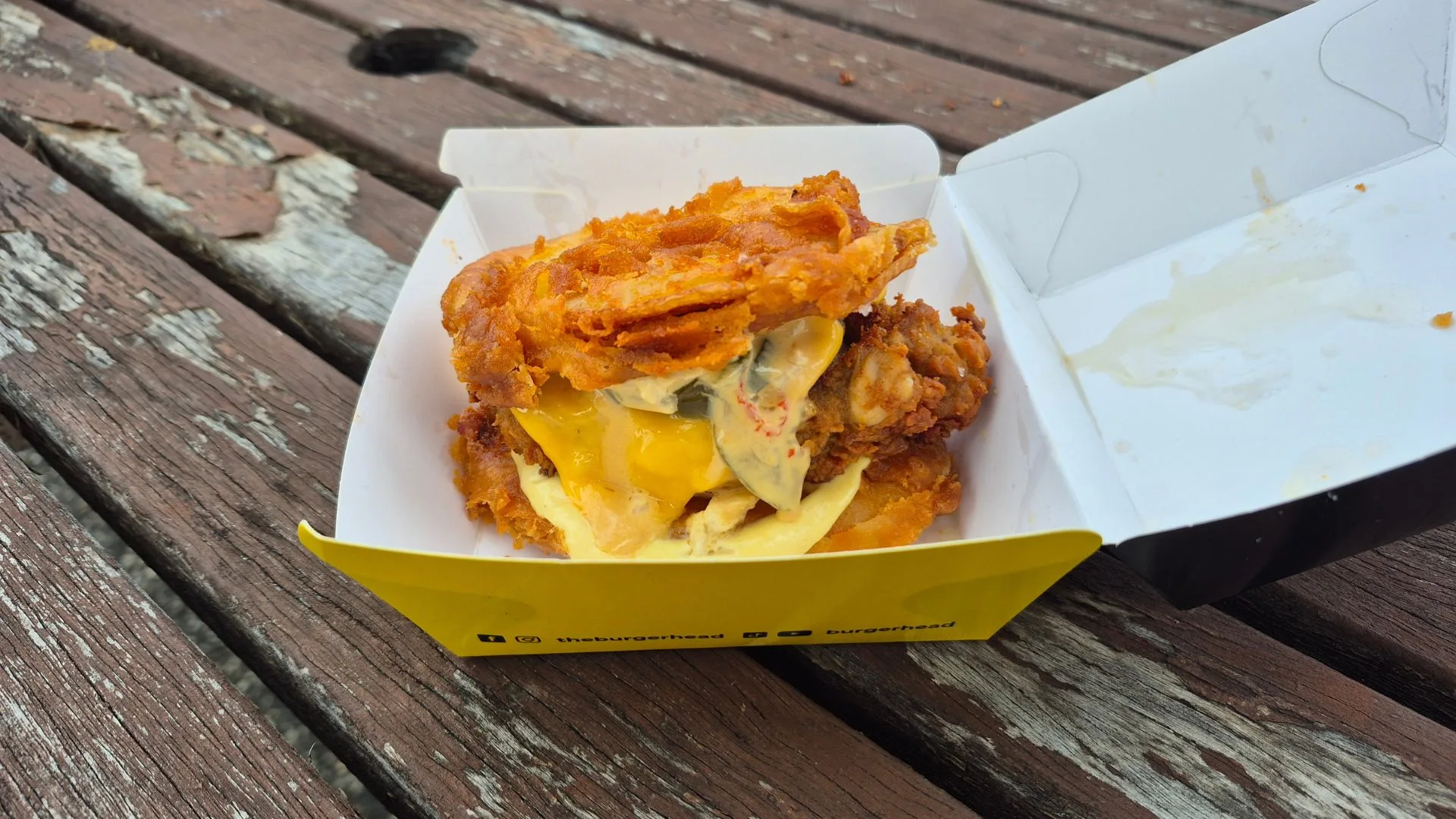 Potato Scallop Chicken Burggah in a yellow take-away box
