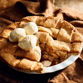 Deep dish gluten-free apple pie with almond crust, served with vanilla ice-cream