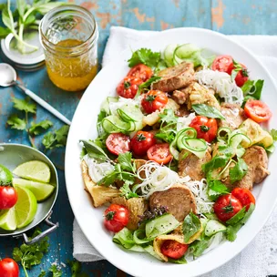 Sweet and sour pork with rice noodle salad on a serving platter