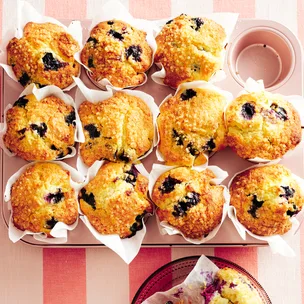 Blueberry muffins straight from the oven in muffin tins