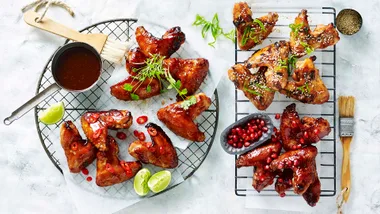four types of chicken wings on metal racks