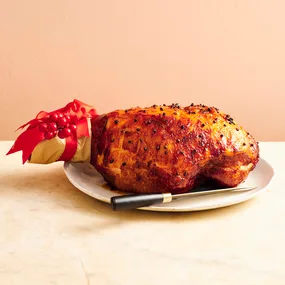 clove-studded marmalade glazed ham on a plate