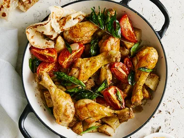 chicken drumsticks and potato in a large pot with handles