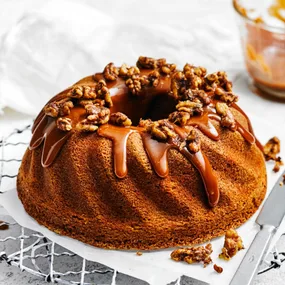 coffee and walnut cake with icing and walnuts on top