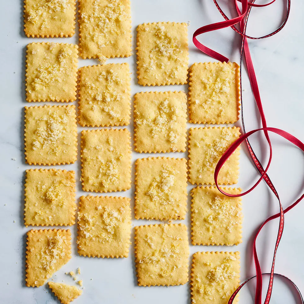 salted lemon shortbread squares on a bench with red ribbon alongside