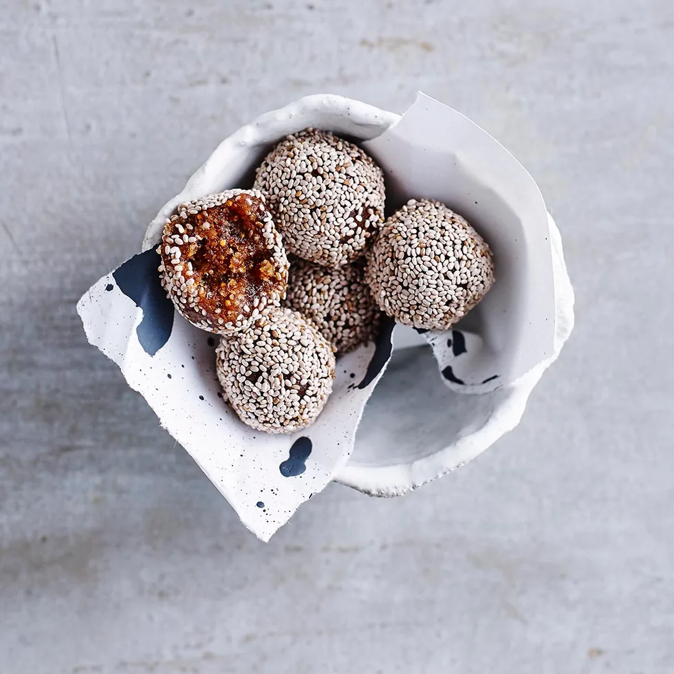 macadamia and fig bliss balls in a baking paper lined bowl