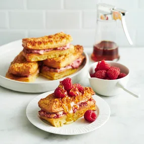 air fryer French toast crumpet fingers on a plate topped with raspberries