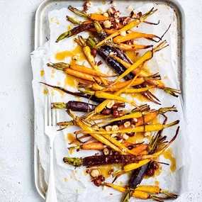 Air fryer carrots with garlicky maple syrup glaze and crunchy hazelnuts