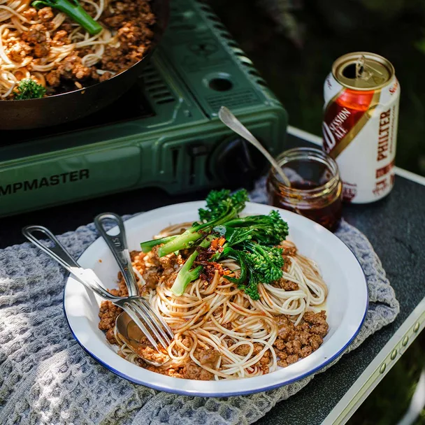 5 ingredient dan dan noodles in a bowl, cooked on a camp gas stove