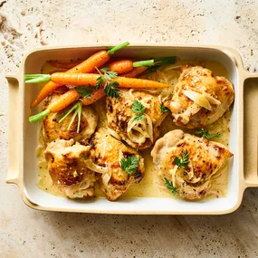 Honey mustard chicken thighs tray bake recipe served with carrots