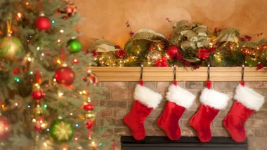 Christmas stockings hanging on the fireplace near the Christmas tree