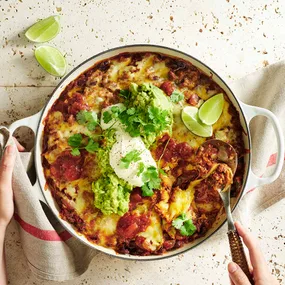 burrito bake in the pan with a scoop