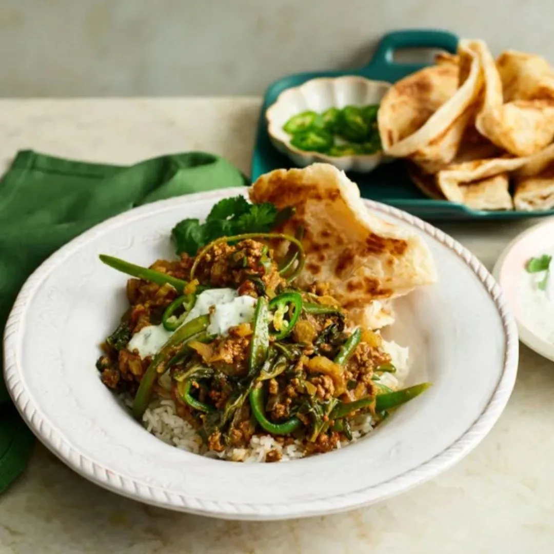 mince and rice recipes curried mince in a white bowl with rice and roti