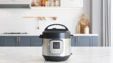 Multi Cooker On Empty Marble Surface With Blurred Kitchen Background