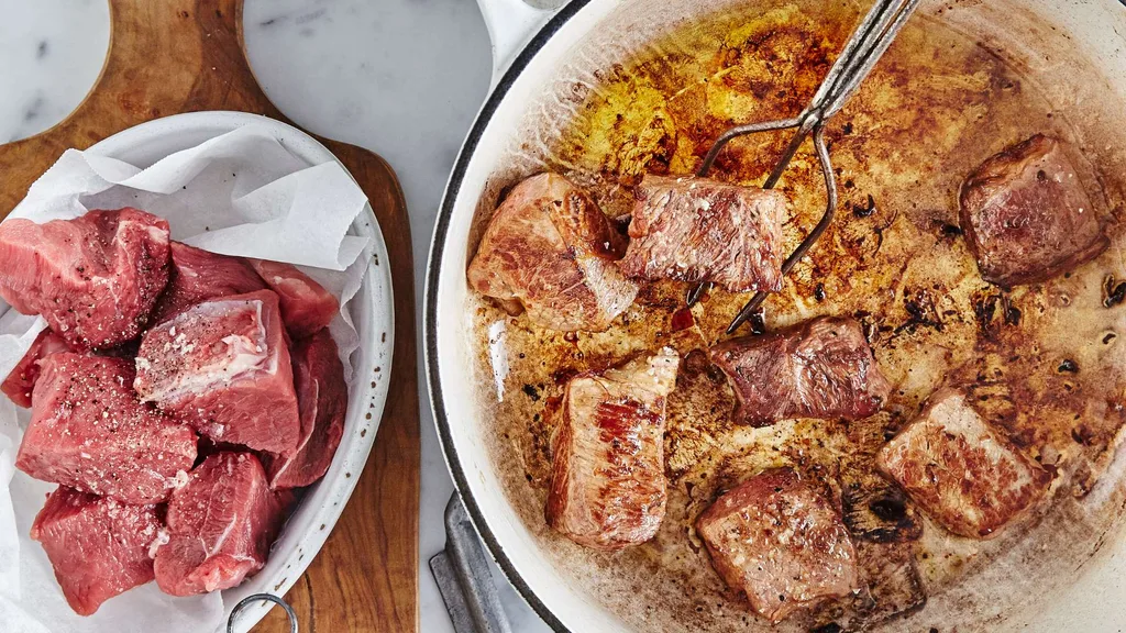 Browning the beef in a frying pan