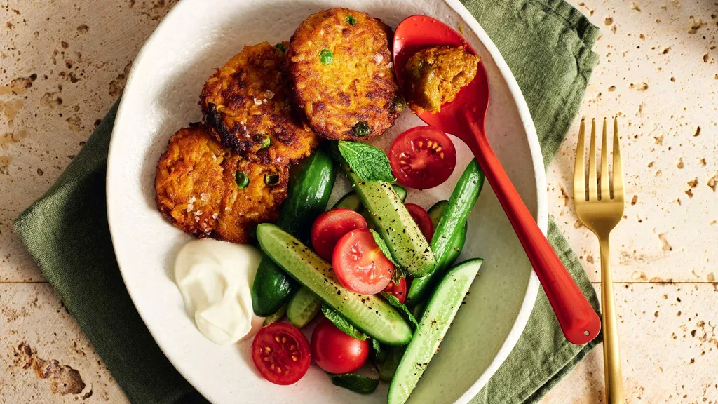 Pumpkin and rice fritters served with natural yoghurt, lime pickle, fresh mint and salad