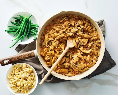 Julie Goodwin's chicken stroganoff in the pan with pasta and beans on the side