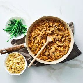 Julie Goodwin's chicken stroganoff in the pan with pasta and beans on the side